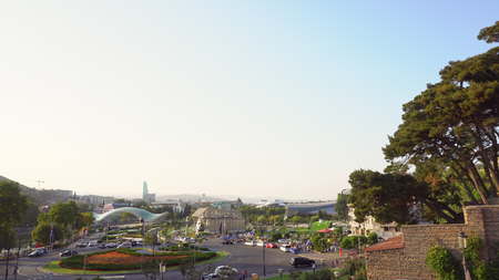 Panorama view of Tbilisi, capital of Georgia country. Cable road above tiled roofs.