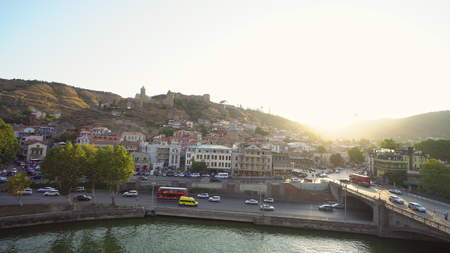 Panorama view of Tbilisi, capital of Georgia country. Cable road above tiled roofs.