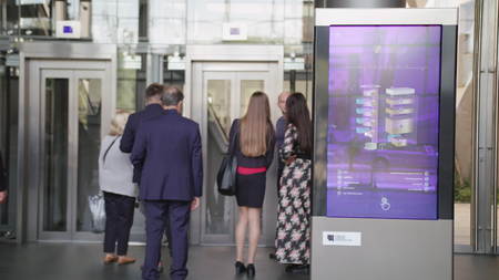 Lublin, Poland - September 2017: People going in and out of a business center. Information Board...