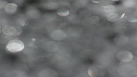 The Anamorph Bokeh stock video features a circle rotation in a clockwise direction of grey blurred...