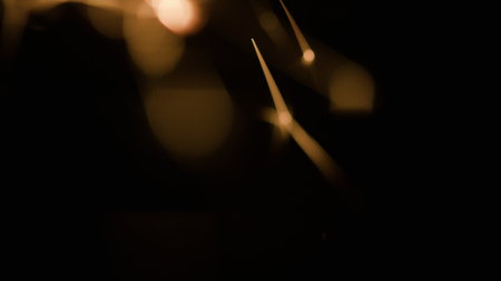 Magic glowing Flow of Sparks in the Dark. You can use Slow Motion Sparks as an overlay for creative video effects, artistic videos, and as a texture by changing the blending mode to add or screen.の写真素材