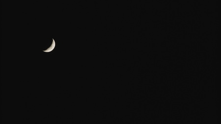 New moon in the pitchblack sky. Long shotの写真素材