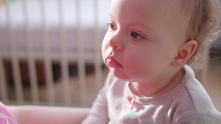 Babys sitting in bed at home. Close-up shotの写真素材