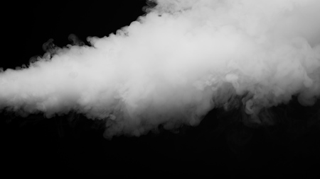 White clouds of vapor smoke are isolated on a black background. Gas explodes, swirl and dances in...