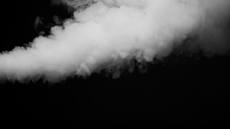 White clouds of vapor smoke are isolated on a black background. Gas explodes, swirl and dances in space. A magic fog dust texture effect that can be used by overlay and changing their transparency.の写真素材