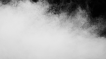 White clouds of vapor smoke are isolated on a black background. Gas explodes, swirl and dances in space. A magic fog dust texture effect that can be used by overlay and changing their transparency.の写真素材