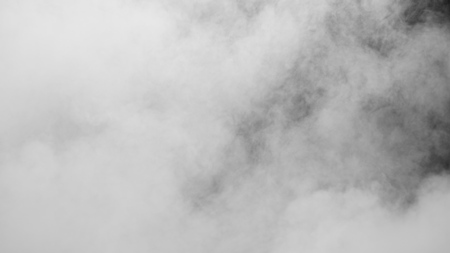 White clouds of vapor smoke are isolated on a black background. Gas explodes, swirl and dances in space. A magic fog dust texture effect that can be used by overlay and changing their transparency.の写真素材