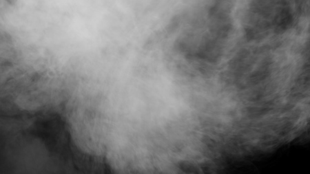 White clouds of vapor smoke are isolated on a black background. Gas explodes, swirl and dances in space. A magic fog dust texture effect that can be used by overlay and changing their transparency.の写真素材