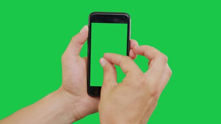 Zooming Out Smartphone Green Screen. Pointing Finger Clicking On Phone Screen with Green Background. Use in any project that depicts finger, gesture, touchscreen and the like.の写真素材