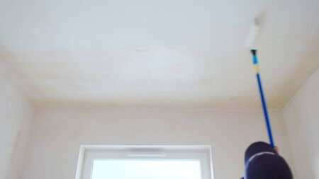 Man painting the room white. Decoration