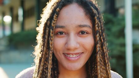 Lady with braids. Emotion. Smile Closeup shot