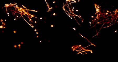 The fire spreads through the smoldering steel wool, forming many sparks and isolated beautiful combustion on black background that looks like strands of neurons in the brainの写真素材