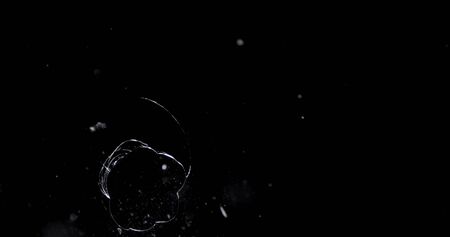 Shattered and broken glass shards flying through the air after crush broken window on a black backgroundの写真素材