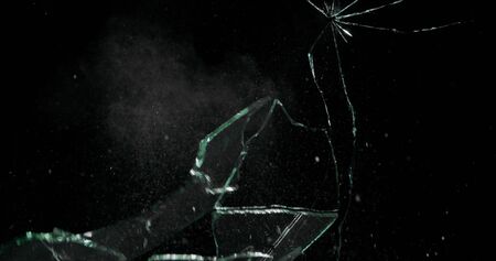 Real frost on a window. Frostwork pattern ice crystals on black background. Dark surface with...