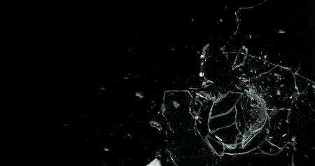 Real frost on a window. Frostwork pattern ice crystals on black background. Dark surface with...