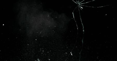 Real frost on a window. Frostwork pattern ice crystals on black background. Dark surface with...