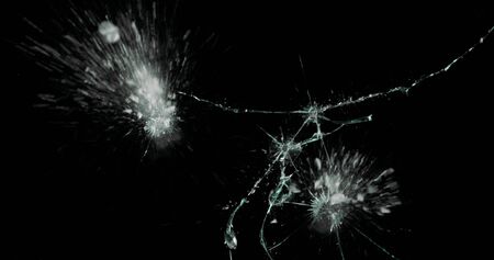 Real frost on a window. Frostwork pattern ice crystals on black background. Dark surface with...