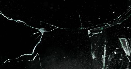 Real frost on a window. Frostwork pattern ice crystals on black background. Dark surface with abstract ice structure makes to overlay or add a frost effect.の写真素材