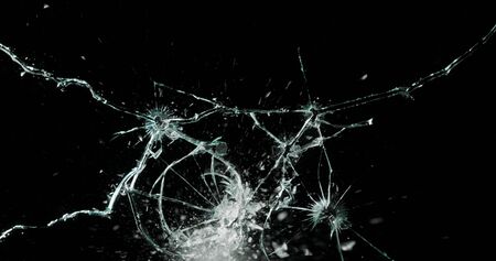 Real frost on a window. Frostwork pattern ice crystals on black background. Dark surface with...
