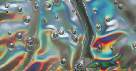 Bubbles Among Psychedelic Colors. Small bubbles in a melting iridescent plastic causing psychedelic colors.の写真素材