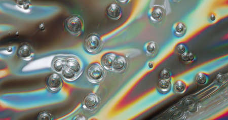 Bubbling Metallic Sheet. Metallic vinyl sheet with bubble pockets forming on its surface.の写真素材