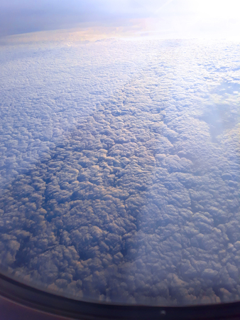 landscape from the mirror of aircraft.with fare Light from the sunの写真素材