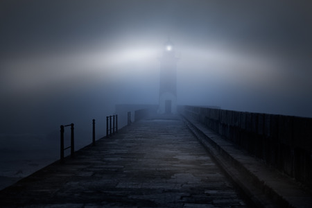 River mouth lighthouse and granite pier in a foggy night River mouth lighthouse and granite pier in a foggy night