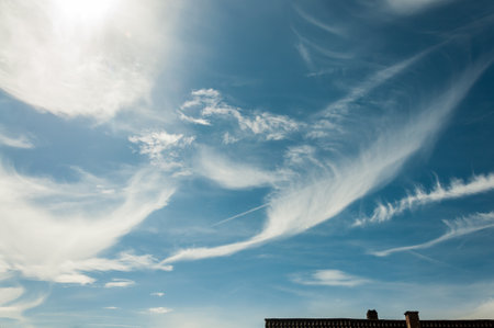 A Beautiful Scene of Serene Skies with Wispy Clouds Set Against a Clear Blue Backgroundの写真素材