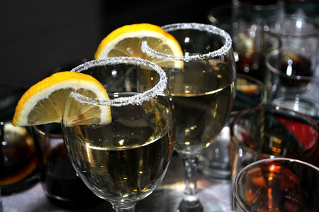 Focused glass of vermouth with a slice of lemon, thinly lined top of the glass with a layer of sweet sugar in the restaurant, Novi Sad, Serbiaの写真素材