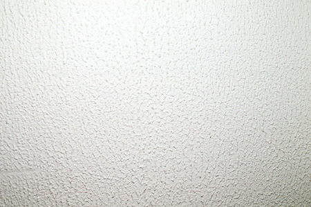 Background lighted white rough wallの写真素材