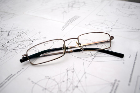 Student glasses left on plans for construction