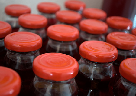 Juices made of natural grown raspberries with red blind plugsの写真素材