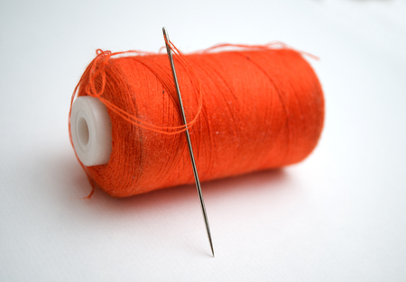 The orange thread with a needleの写真素材