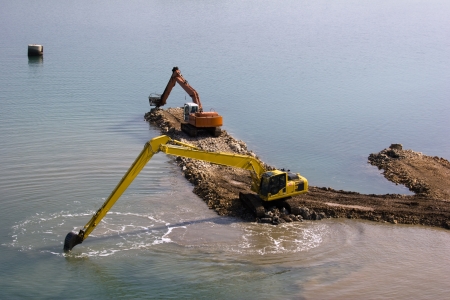 Two backhoes are deepen the seabed between islands Ugljan and Pasman in Croatiaの写真素材