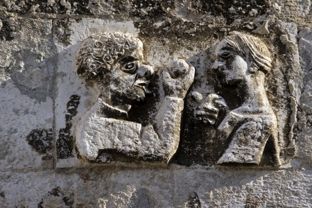 Adam takes apple from Eva, stone relief on the west wall of Diocletian palace in Split, Croatiaの写真素材