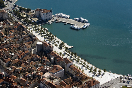 Aerial view of town Split with red roofs, coastline and blue sea in the harbourのeditorial素材