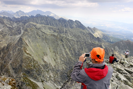 Mountaineer takes photo of of High Tatras from peak Krivan in Slovakiaの写真素材