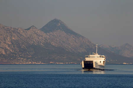 White ferry boat between town Makarska and Sumartin on Adriatic sea in Croatiaの写真素材