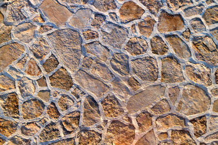 Floor and wall mosaic of rough natural stone grouted with concreteの写真素材