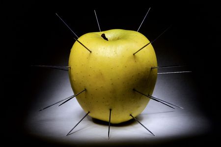 spiked apple isolated on blackの写真素材