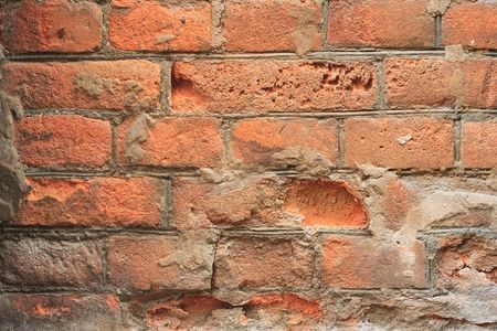 decayed red brick wall