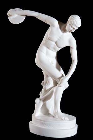 Classical white marble statue of naked discus thrower isolated on black backgroundの写真素材