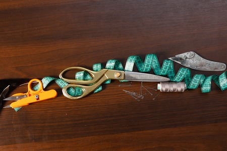 Professional tailor's tools for cutting and sewing, scissors, flexible ruler tape, thread nipperの写真素材