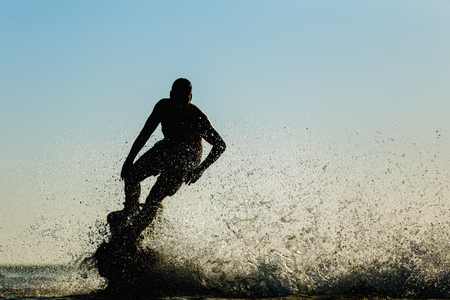 Silhouette of a fly board rider at seaの写真素材