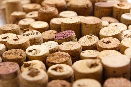 Closeup of a wall of used wine corks. A random selection of used wine corks, some with vintage years.の写真素材