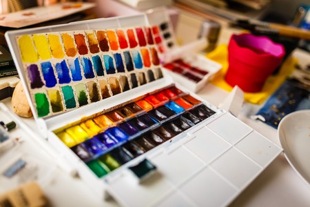 Box  of watercolors on working artist tableの写真素材