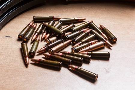 7.62 ammo for machine guns with loaded magazines on tableの写真素材