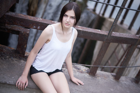 Concept: gritty, millennial. Gorgeous beautiful young woman photoshoot in abandoned location presenting the contrast of fashion and grunge.の写真素材