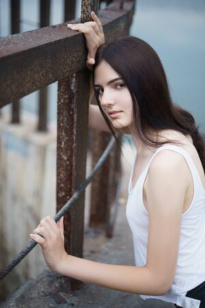 Concept: gritty, millennial. Gorgeous beautiful young woman photoshoot in abandoned location presenting the contrast of fashion and grunge.の写真素材