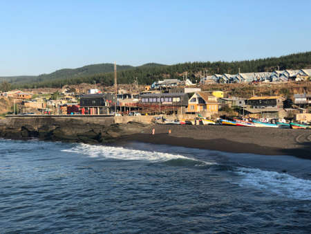 Coastal edge with two silhouettes observing the beachの写真素材